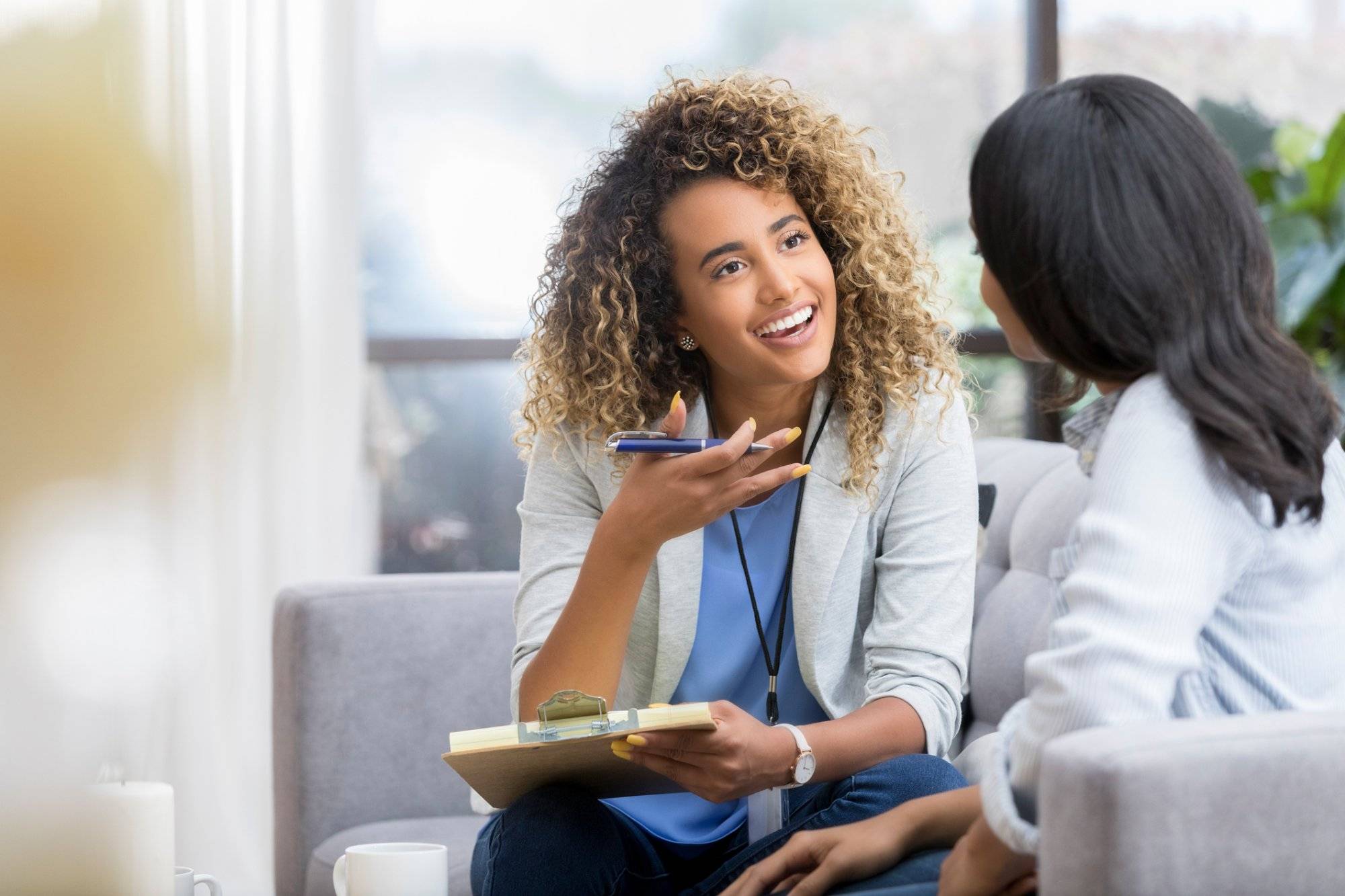 Encouraging therapist talks with young woman Encouraging therapist talks with young woman