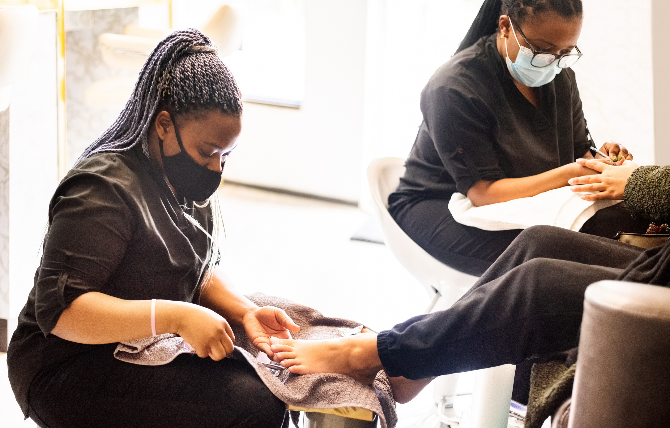 Woman having pedicure and manicure at beauty spa during pandemic