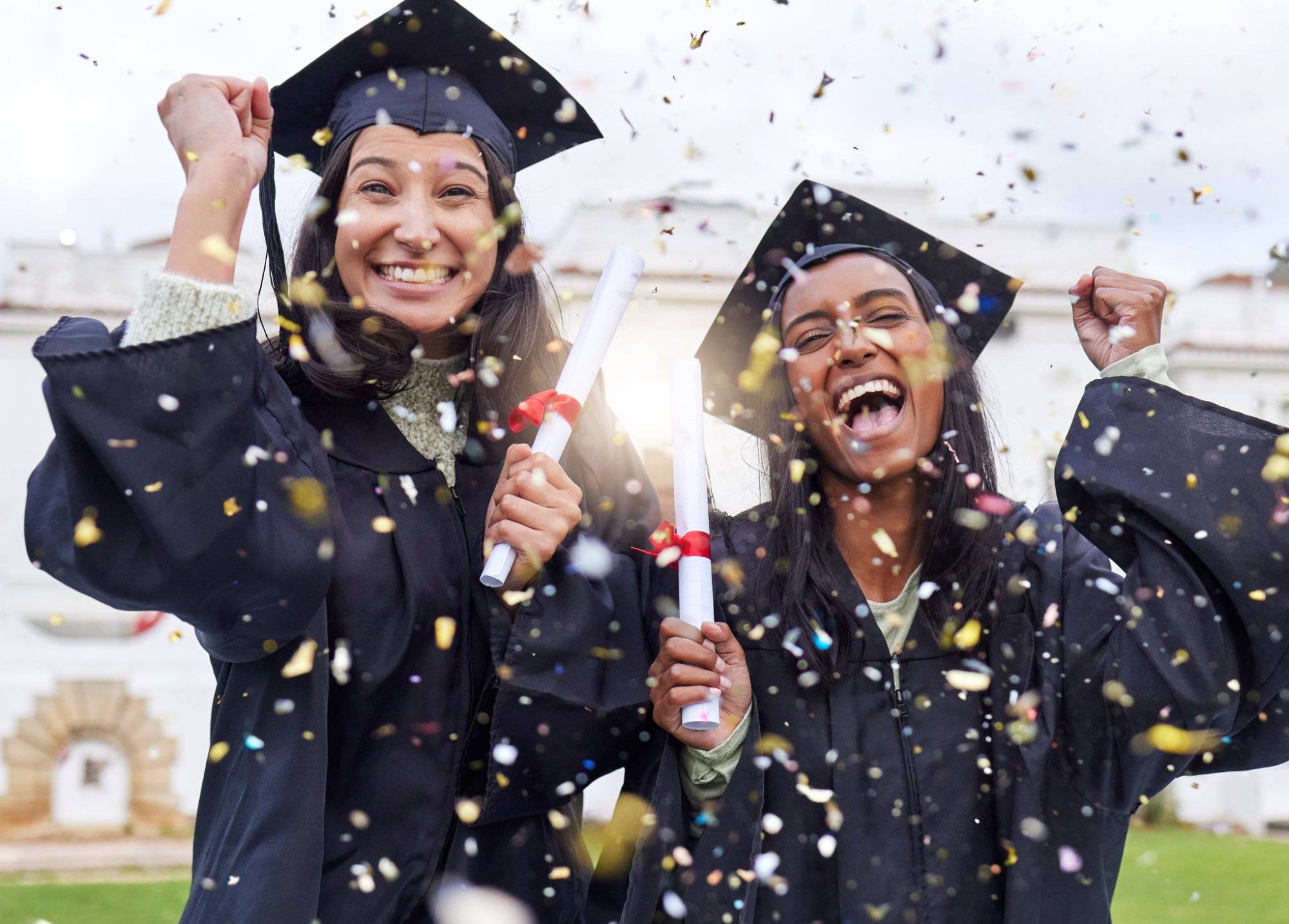 Cropped portrait of two attractive young female students celebrating on graduation day Cropped portrait of two attractive young female students celebrating on graduation day