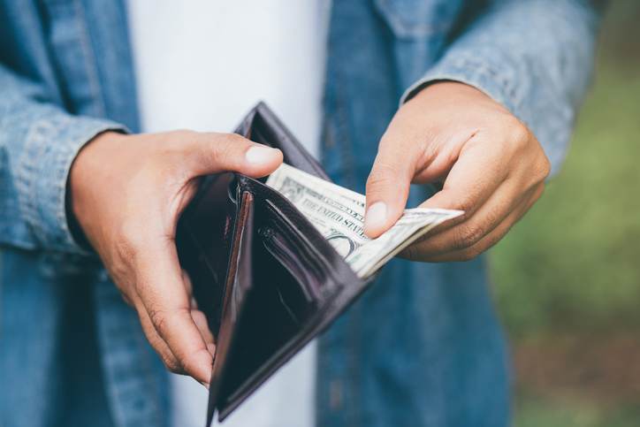 Businessman Person holding an wallet in the hands of an man take money out of pocket. Businessman Person holding an wallet in the hands of an man take money out of pocket.