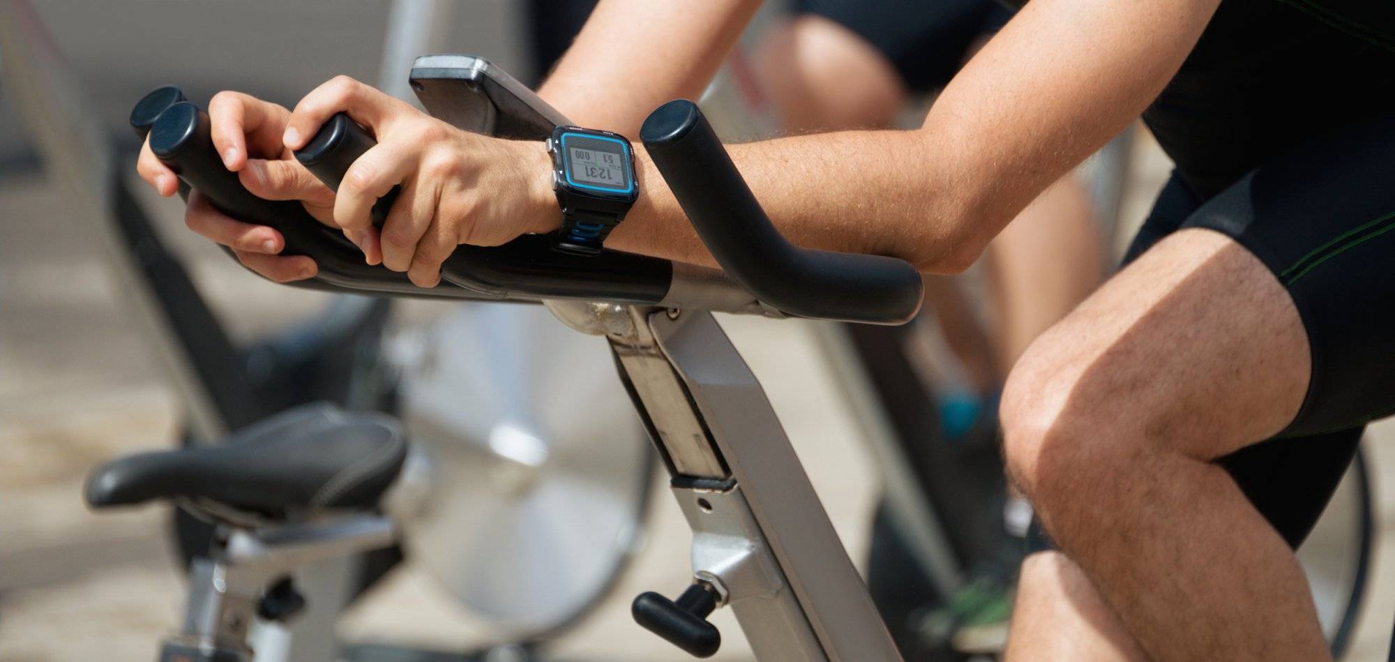 People working out on exercise stationary bicycle