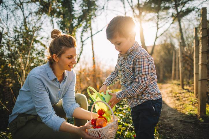 Little boy and his mom on Easter egg hunt