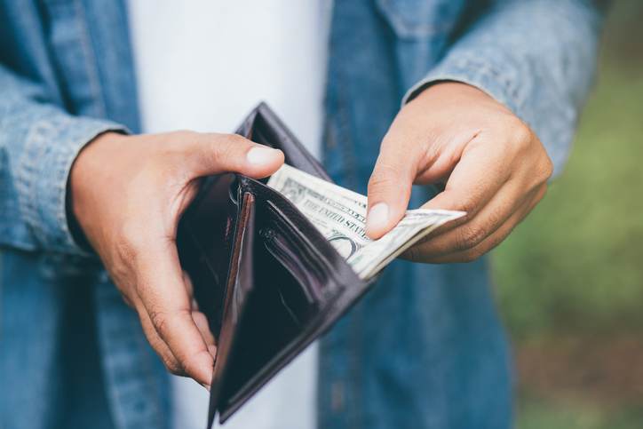 Businessman Person holding an wallet in the hands of an man take money out of pocket.